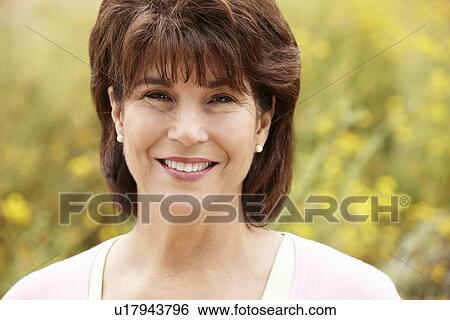 Stock Photograph - Portrait senior hispanic woman outdoors. Fotosearch