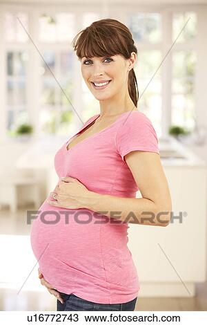Pregnant woman at home View Large Photo Image Stock Image - Pregnant woman at home. Fotosearch