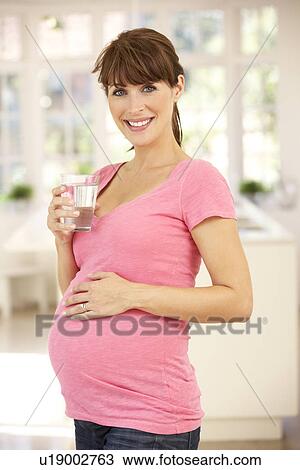 Pregnant woman drinking water View Large Photo Image Stock Image - Pregnant woman drinking water. Fotosearch