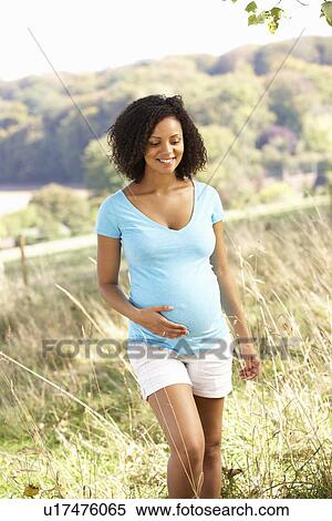 Stock Photography - Pregnant woman outdoors in countryside. Fotosearch