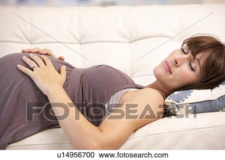 Stock Image - Pregnant woman resting at home. Fotosearch