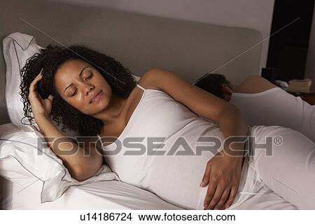 Pregnant woman unable to sleep View Large Photo Image Picture - Pregnant woman unable to sleep. Fotosearch