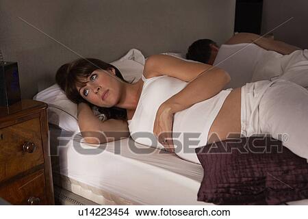 Pregnant woman unable to sleep View Large Photo Image Picture - Pregnant woman unable to sleep. Fotosearch