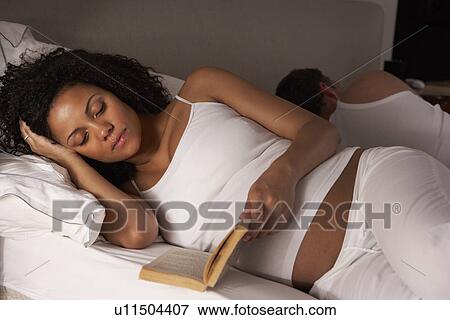 Stock Photo - Pregnant woman unable to sleep. Fotosearch