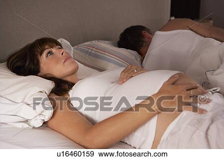 Stock Photo - Pregnant woman unable to sleep. Fotosearch