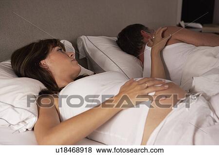 Stock Photo - Pregnant woman unable to sleep. Fotosearch