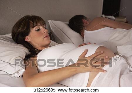 Stock Photography - Pregnant woman unable to sleep. Fotosearch