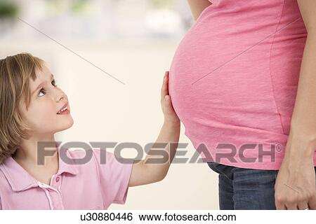 Stock Photograph - Pregnant woman with daughter. Fotosearch