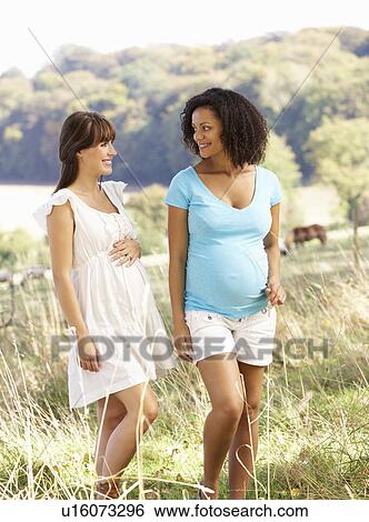 Stock Photograph - Pregnant women outdoors in countryside. Fotosearch