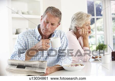 Stock Image - Retired couple eating breakfast. Fotosearch