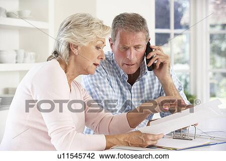 Retired couple with household bills View Large Photo Image Stock Image - Retired couple with household bills. Fotosearch