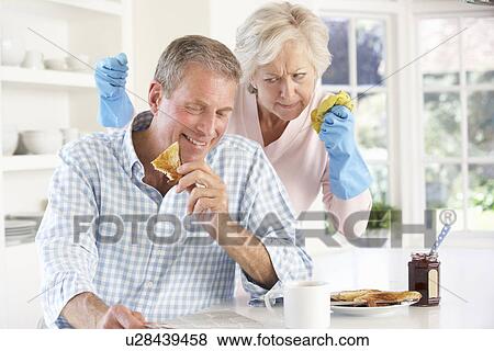 Stock Photo - Retired man not helping with housework. Fotosearch