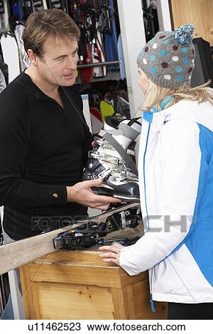 Sales Assistant Helping Advising Female Customer On Ski Boots In Hire Shop View Large Photo Image Stock Image - Sales Assistant Helping Advising Female Customer On Ski Boots In Hire Shop. Fotosearch