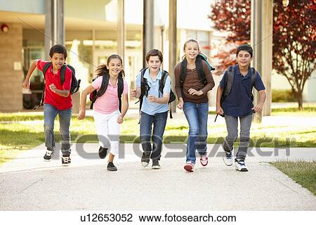 Stock Image - Schoolchildren at home time. Fotosearch