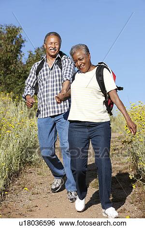 Stock Photograph - Senior couple on country hike. Fotosearch