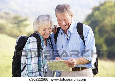 Stock Photograph - Senior couple on country walk. Fotosearch