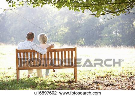 Stock Image - Senior couple sitting outdoors. Fotosearch