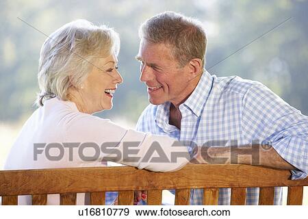 Stock Photo - Senior couple sitting outdoors. Fotosearch