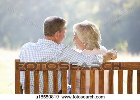Senior couple sitting outdoors View Large Photo Image Stock Photo - Senior couple sitting outdoors. Fotosearch
