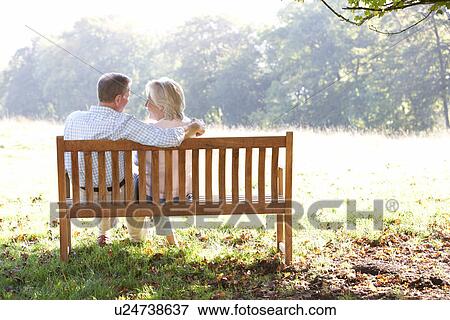 Stock Photo - Senior couple sitting outdoors. Fotosearch
