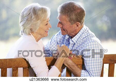 Stock Photograph - Senior couple sitting outdoors. Fotosearch