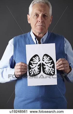 Stock Image - Senior man holding ink drawing of lungs. Fotosearch