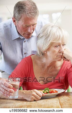 Senior man looking after sick wife View Large Photo Image Stock Image - Senior man looking after sick wife. Fotosearch