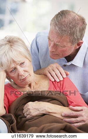 Stock Photo - Senior man looking after sick wife. Fotosearch