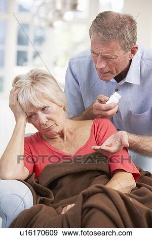 Stock Photo - Senior man looking after sick wife. Fotosearch