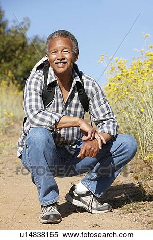 Stock Photography - Senior man on country hike. Fotosearch
