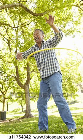 Senior man with hula-hoop View Large Photo Image Stock Image - Senior man with hula-hoop. Fotosearch