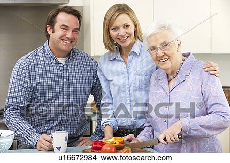 Senior woman and family preparing meal together View Large Photo Image Picture - Senior woman and family preparing meal together. Fotosearch