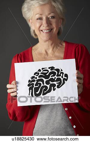 Senior woman holding ink drawing of brain View Large Photo Image Stock Image - Senior woman holding ink drawing of brain. Fotosearch