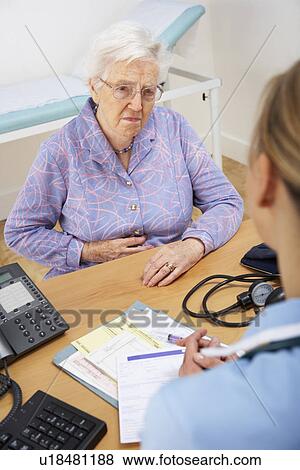 Stock Photo - Senior woman patient with UK nurse. Fotosearch