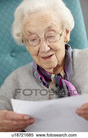 Senior Woman Relaxing In Chair Reading Letter View Large Photo Image Stock Photography - Senior Woman Relaxing In Chair Reading Letter. Fotosearch