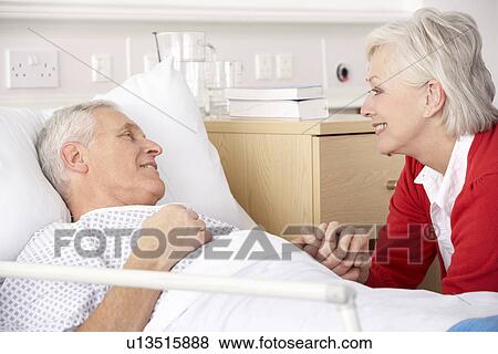 Senior woman visiting husband in hospital View Large Photo Image Stock Photo - Senior woman visiting husband in hospital. Fotosearch
