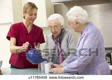 Stock Photo - Senior women at home with carer. Fotosearch