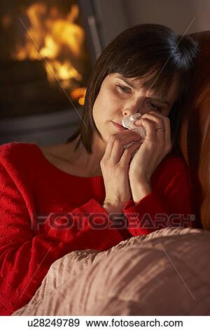 Sick Woman With Cold Resting On Sofa By Cosy Log Fire View Large Photo Image Stock Photo - Sick Woman With Cold Resting On Sofa By Cosy Log Fire. Fotosearch