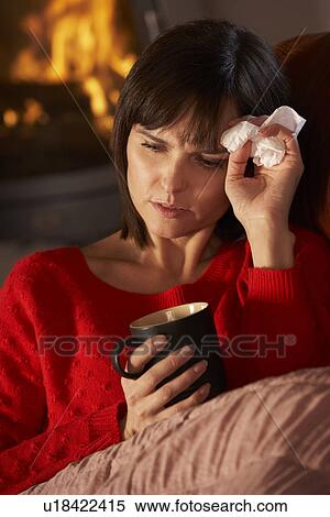 Sick Woman With Cold Resting On Sofa By Cosy Log Fire View Large Photo Image Stock Photography - Sick Woman With Cold Resting On Sofa By Cosy Log Fire. Fotosearch