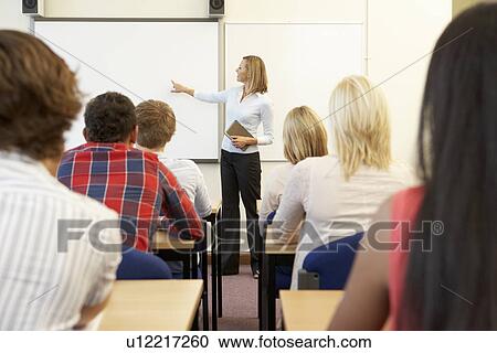 Stock Image - Students and tutor in class. Fotosearch