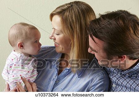 Studio Shot Of Happy Family With Baby View Large Photo Image Picture - Studio Shot Of Happy Family With Baby. Fotosearch
