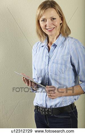Studio Shot Of Middle Aged Woman Using Tablet Computer View Large Photo Image Stock Photo - Studio Shot Of Middle Aged Woman Using Tablet Computer. Fotosearch