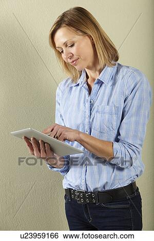 Studio Shot Of Middle Aged Woman Using Tablet Computer View Large Photo Image Stock Photograph - Studio Shot Of Middle Aged Woman Using Tablet Computer. Fotosearch