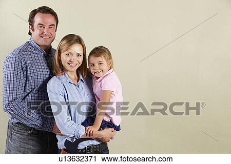 Stock Image - Studio Shot Of Relaxed Family. Fotosearch