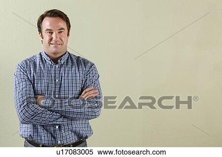 Stock Photography - Studio Shot Of Relaxed Middle Aged Man. Fotosearch