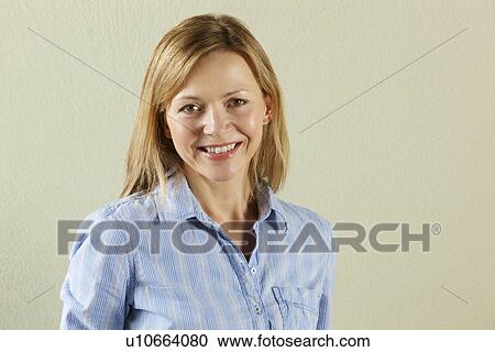 Stock Image - Studio Shot Of Relaxed Middle Aged Woman. Fotosearch