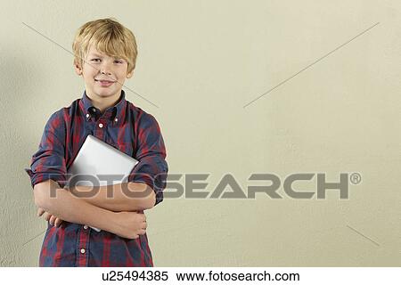 Studio Shot Of Young Boy Holding Tablet Computer View Large Photo Image Stock Photography - Studio Shot Of Young Boy Holding Tablet Computer. Fotosearch