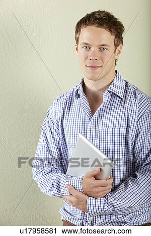 Studio Shot Of Young Man Holding Tablet Computer View Large Photo Image Stock Image - Studio Shot Of Young Man Holding Tablet Computer. Fotosearch