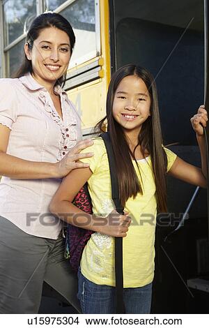 Teacher seeing pupil onto school bus View Large Photo Image Picture - Teacher seeing pupil onto school bus. Fotosearch