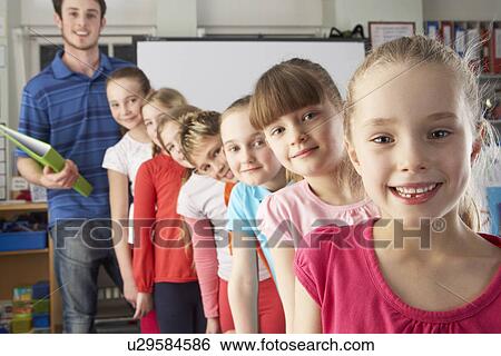 Teacher with line up of children in class View Large Photo Image Stock Photograph - Teacher with line up of children in class. Fotosearch